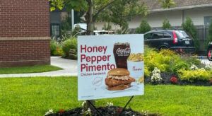 Chick-fil-A Honey Pepper Pimento Chicken Sandwich topped with pimento cheese and honey