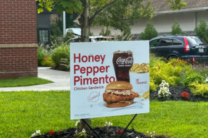 Chick-fil-A Honey Pepper Pimento Chicken Sandwich topped with pimento cheese and honey