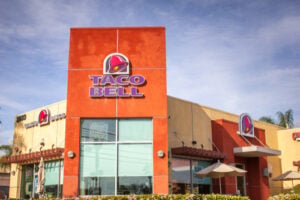 History of Taco Bell Mexican Pizza served with its signature layers of tortillas, beans, beef, cheese, tomatoes, and sauce